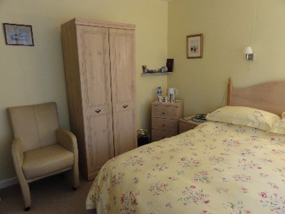 Bedroom No2 chair, wardrobe, bed and drink making facilities